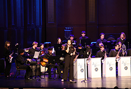  Students play instruments and one signs